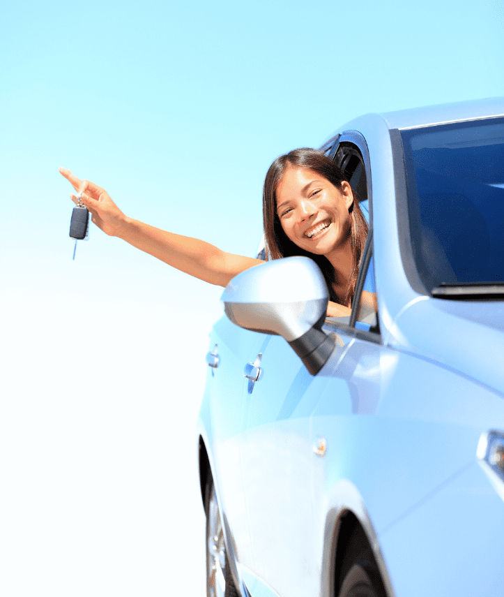 Smiling woman sitting in her new car after getting approved for a car loan in NZ