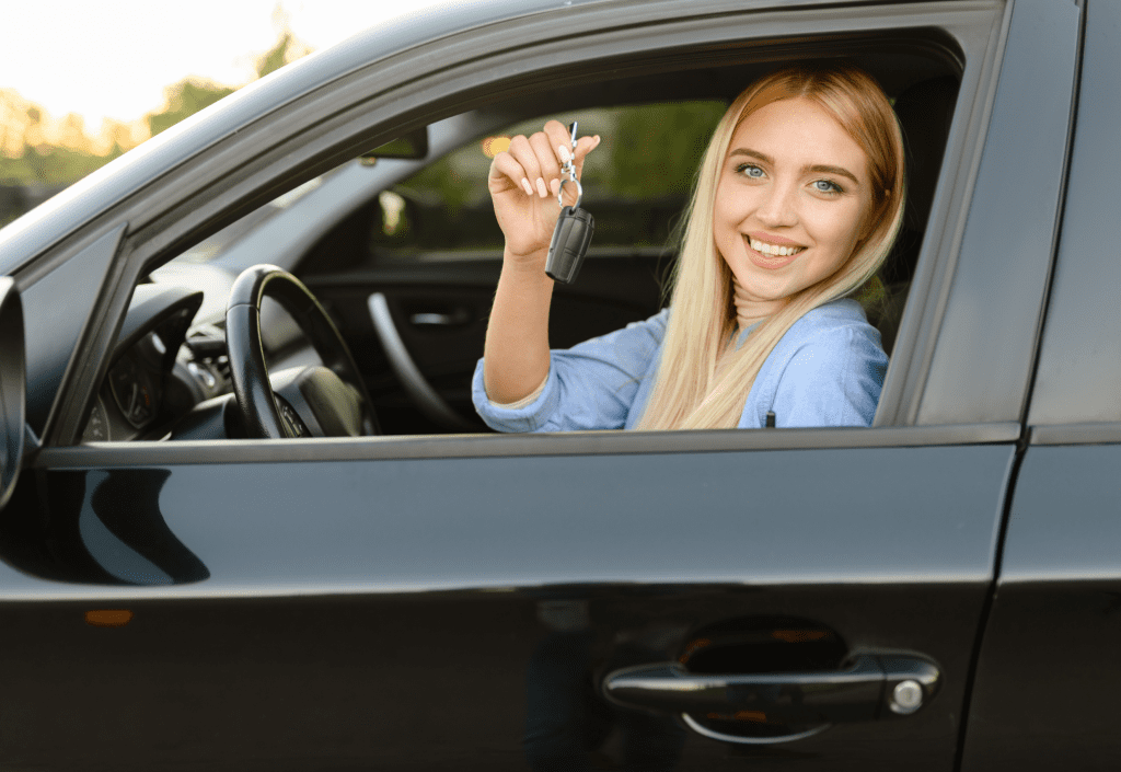 Excited woman holding car keys after getting approved for a car loan in New Zealand